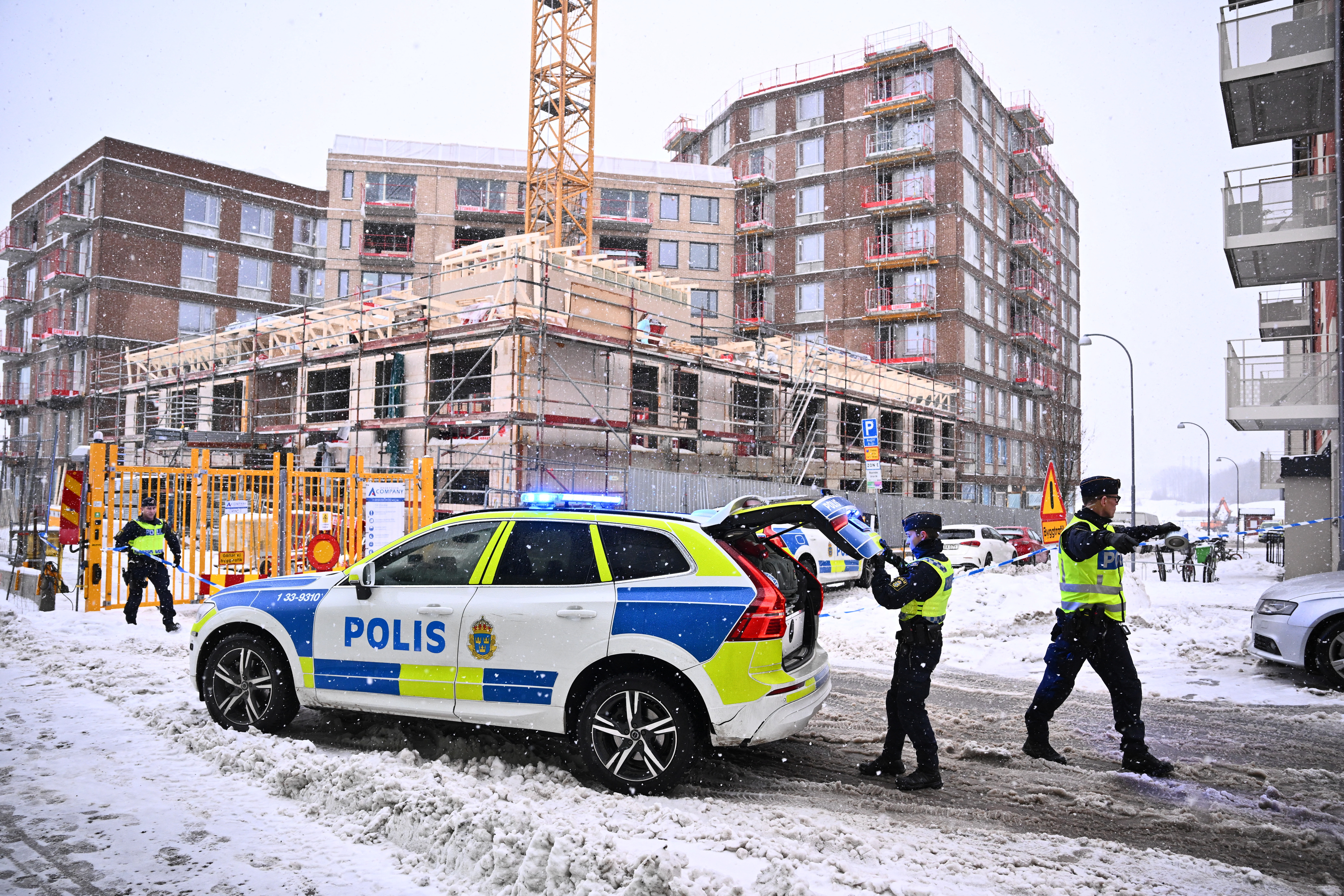 Police officers work following a construction elevator accident in Sundbyberg, north of Stockholm