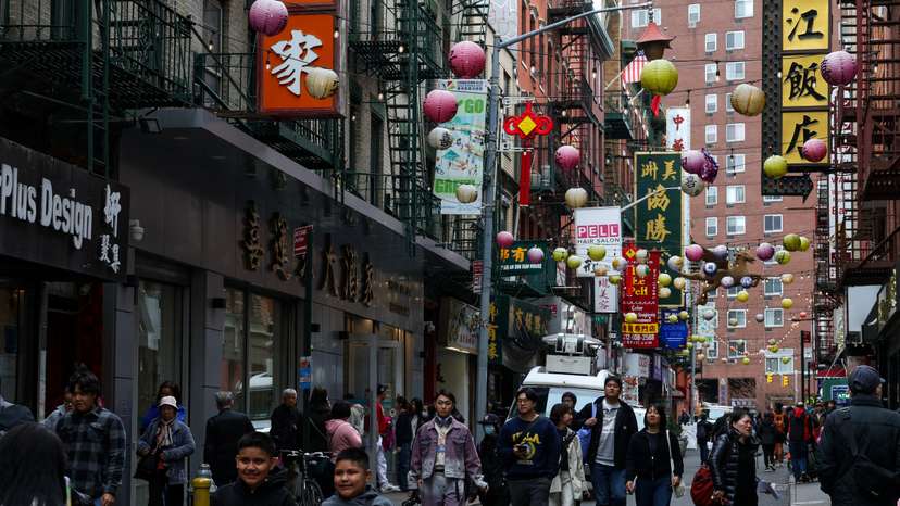 People walk through Chinatown in New York