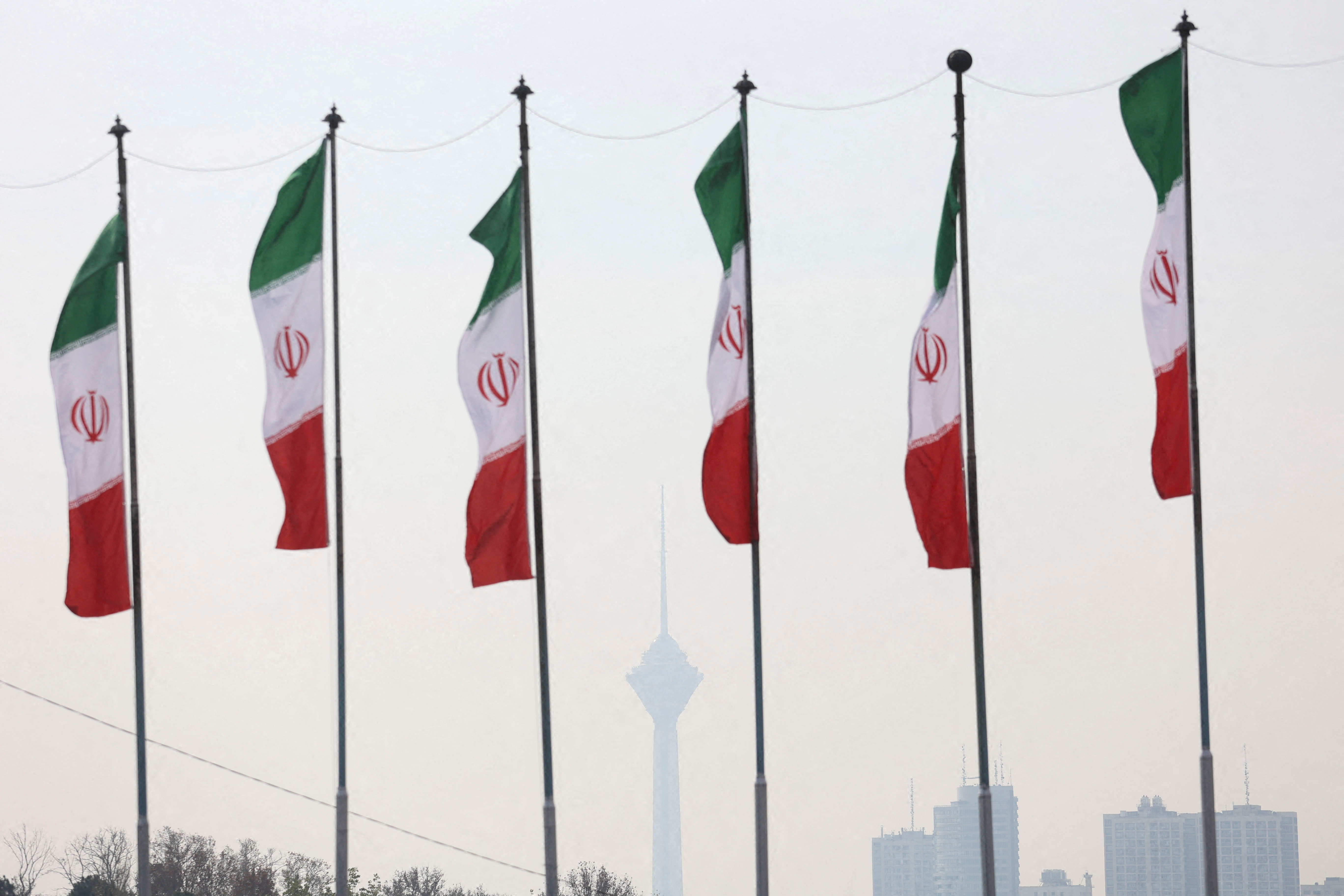 FILE PHOTO: Iranian flags flutter as the Milad Tower is covered in smog following the increase in air pollution in Tehran