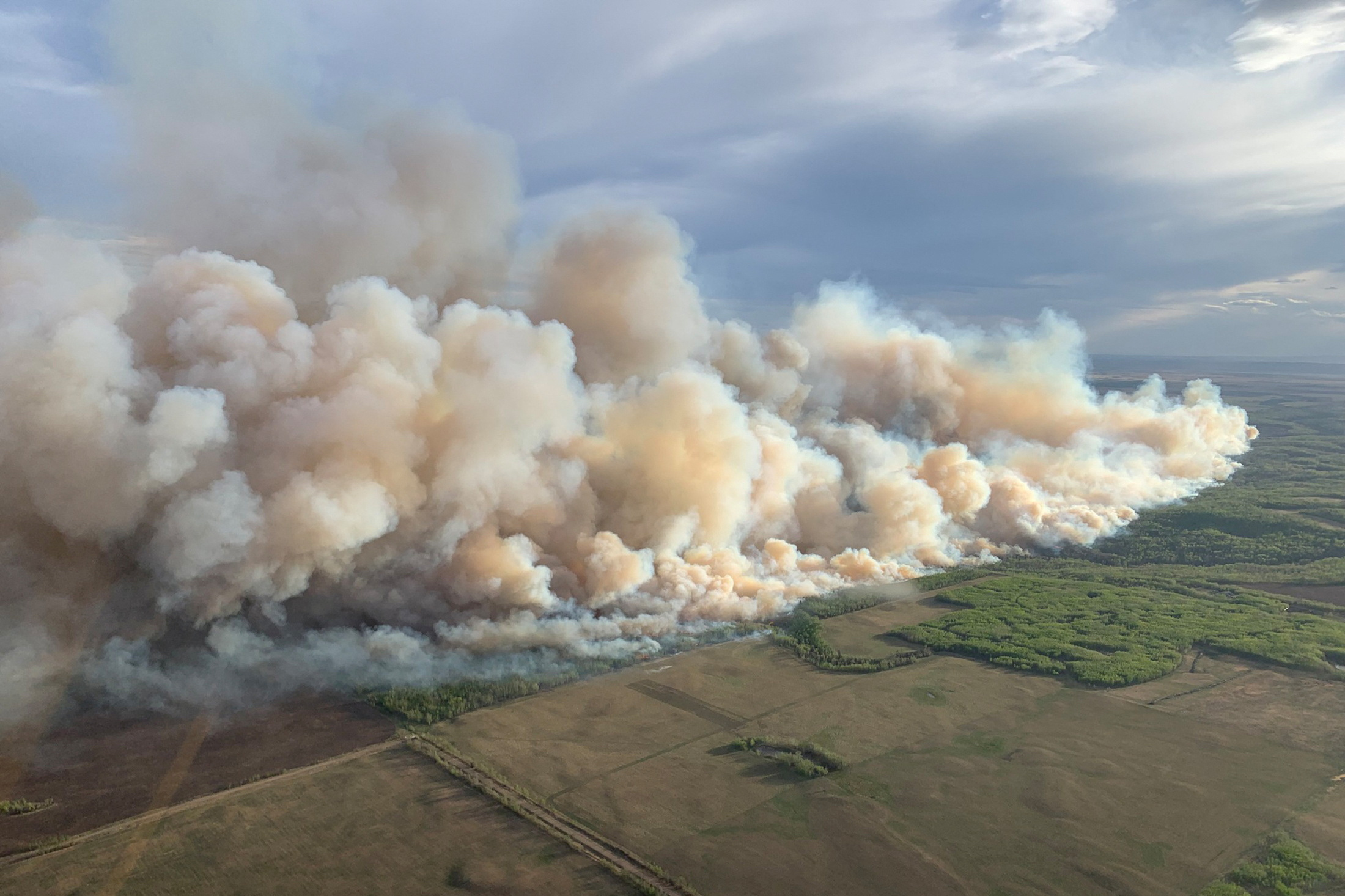 Smoke rises from mutual aid wildfire GCU007 in the Grande Prairie Forest Area