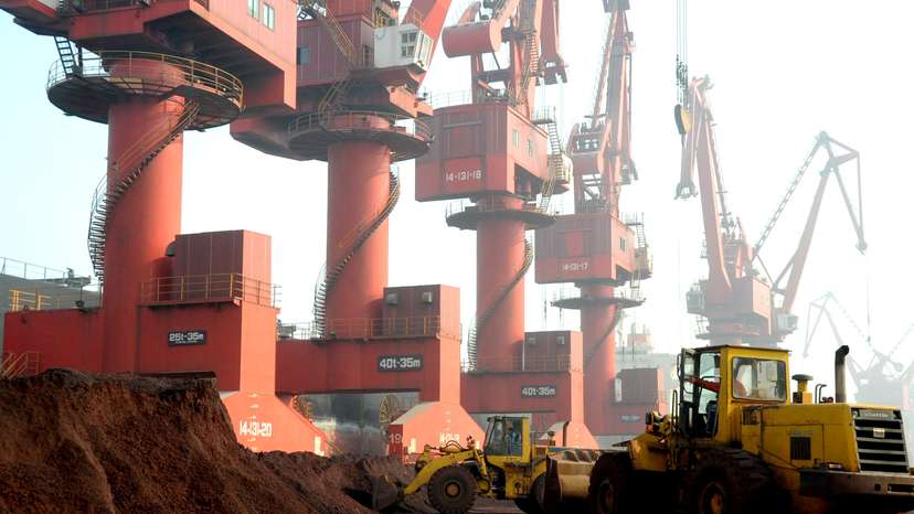 FILE PHOTO: Workers transport soil containing rare earth elements for export at a port in Lianyungang