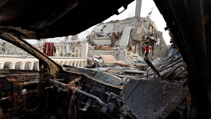 Palestinians inspect the site of an Israeli strike on a house, in Rafah, in the southern Gaza Strip