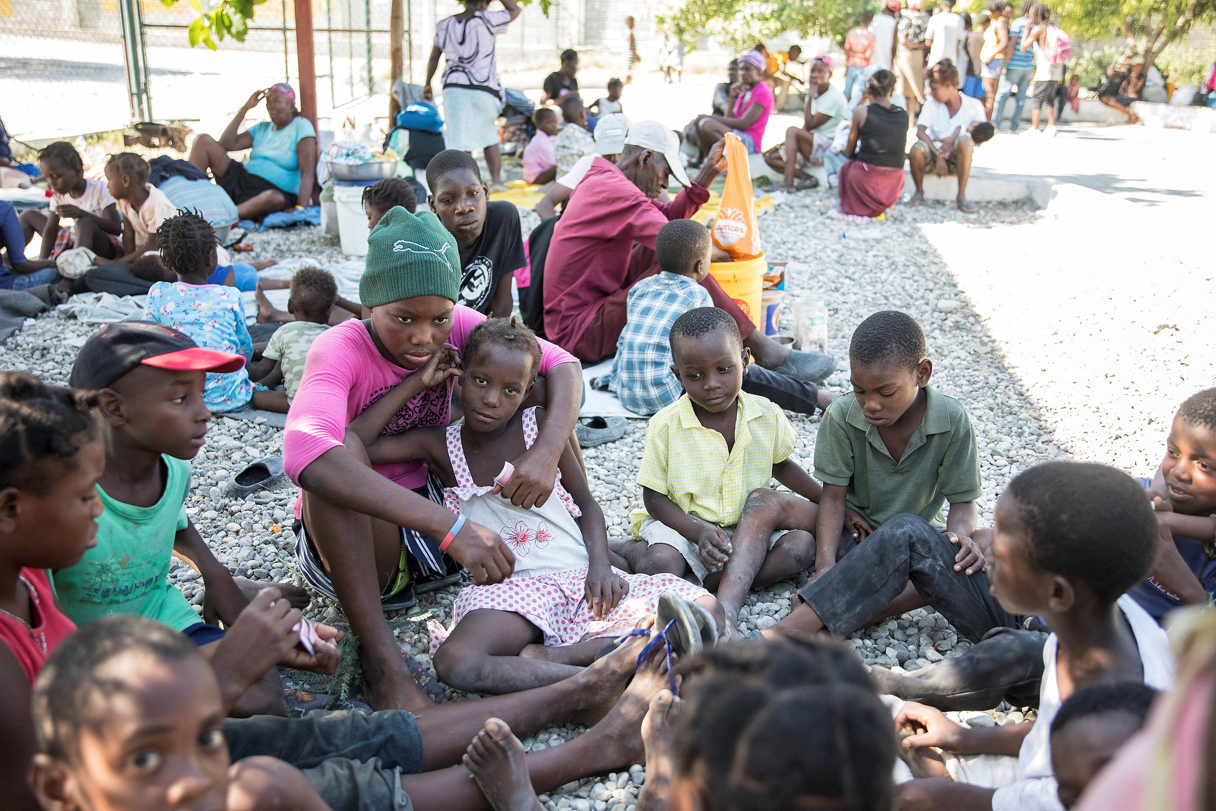 FILE PHOTO: People fleeing from violence after the murder of a local gang leader camp out in the courtyard of Cite Soleil's town hall, in Port-au-Prince