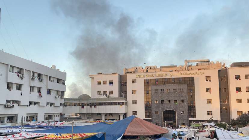 Smoke rises as displaced Palestinians take shelter at Al Shifa hospital, amid the ongoing conflict between Hamas and Israel, in Gaza City