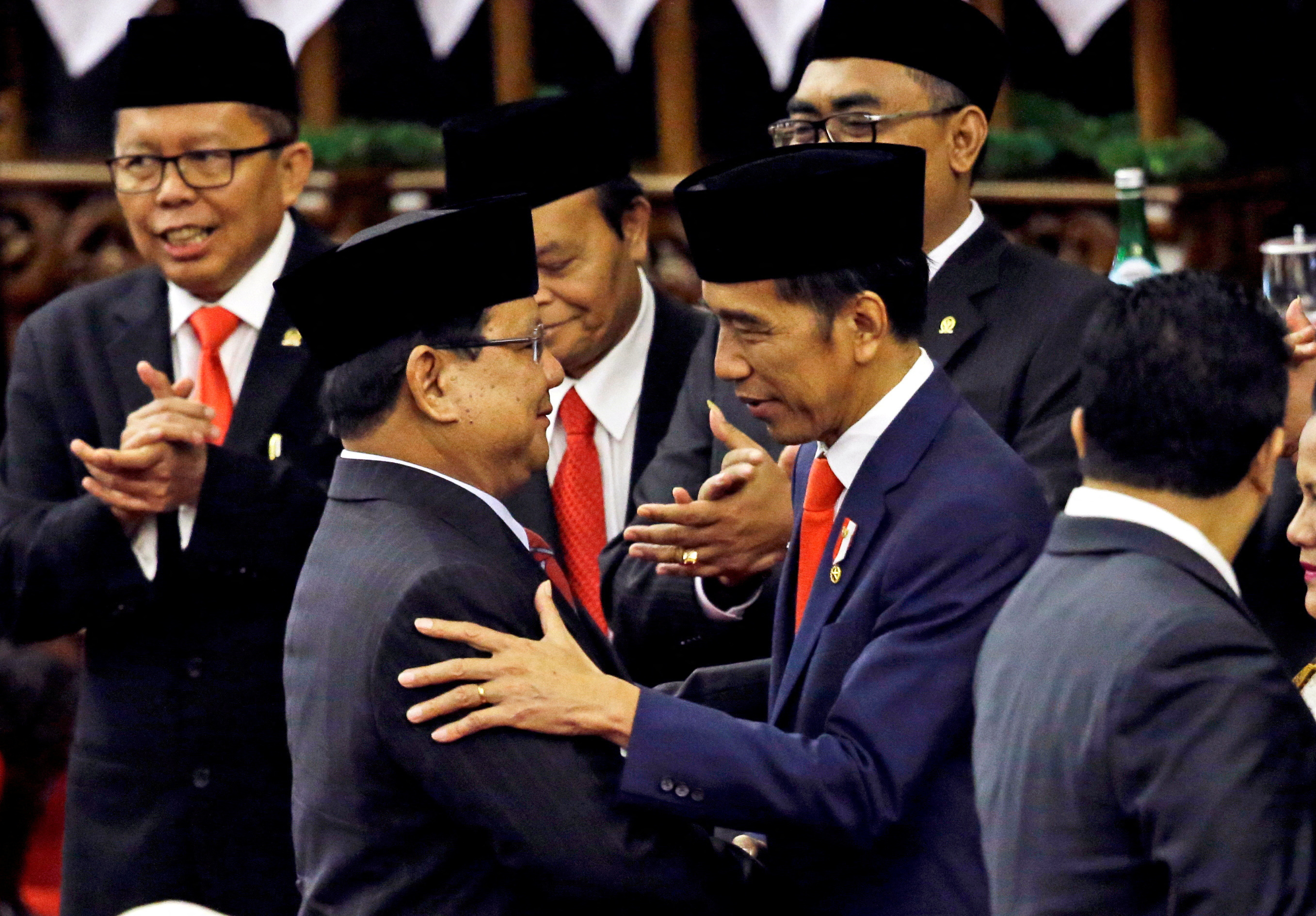 FILE PHOTO: Indonesian President Joko Widodo is congratulated by the Gerindra Party Chairman Prabowo  Subianto, who was his former rival in April's election, after his presidential inauguration for the second term, at the House of Representatives building