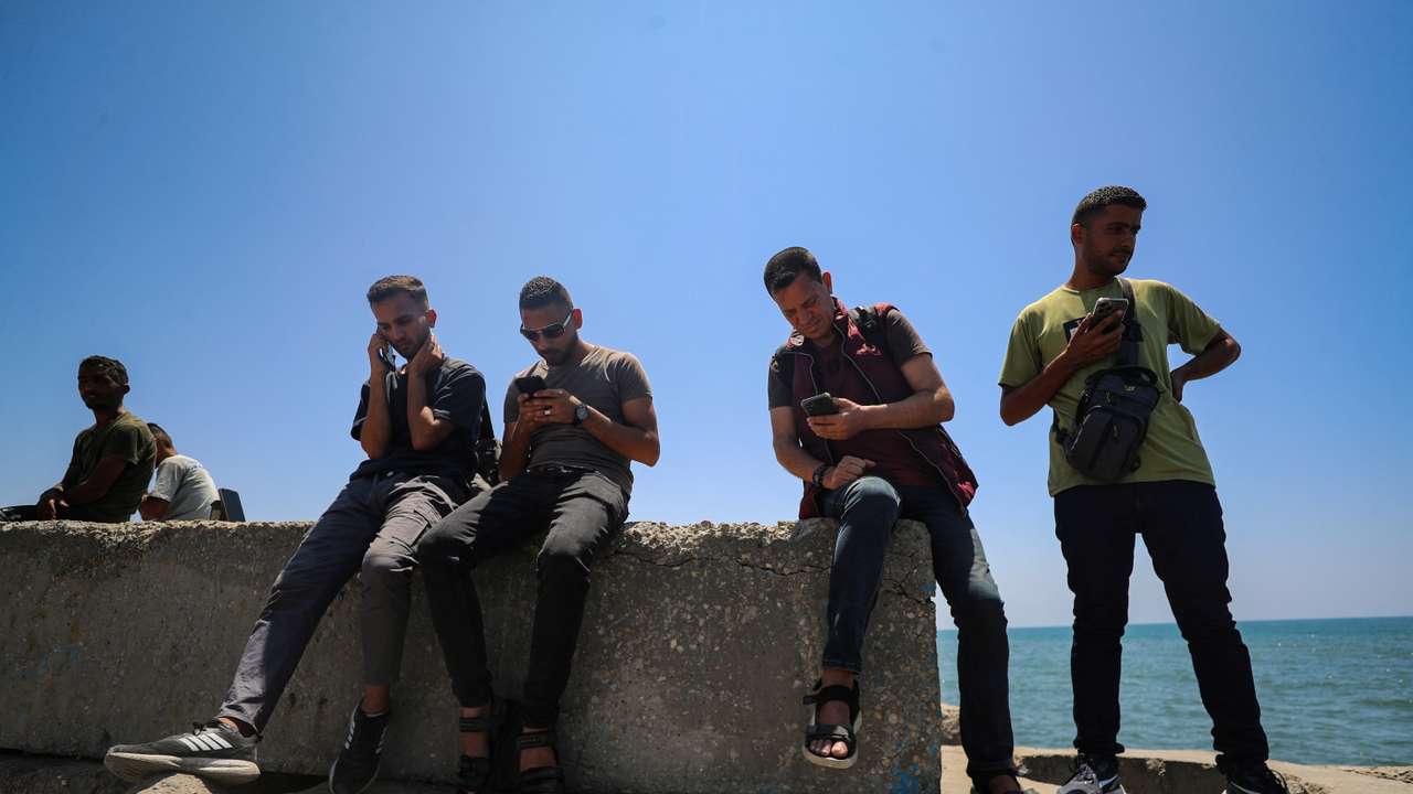 Palestinians attempt to access the internet using eSIMs, in Gaza City