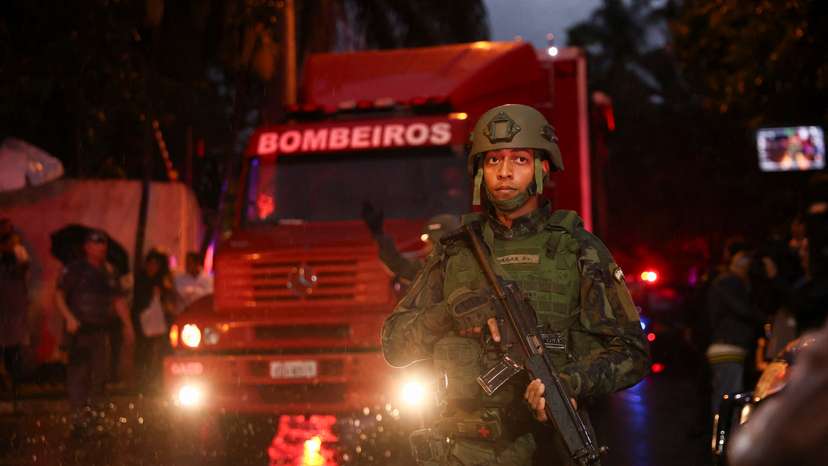 Authorities arrive at the site where a turboprop plane crashed near Sao Paulo