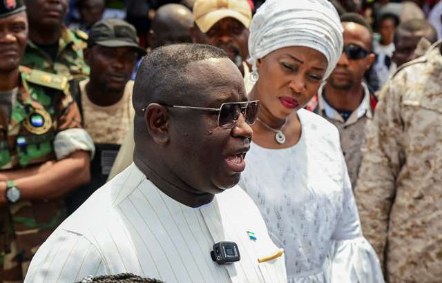 FILE PHOTO: Sierra Leone's President and ruling party candidate Julius Maada Bio speaks to journalists after casting his vote for national elections at a polling station in Freetown, Sierra Leone, June 24, 2023. REUTERS/Cooper Inveen/File Photo