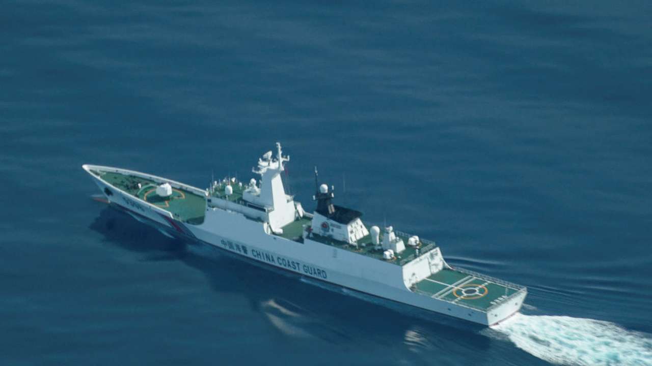 An aerial view of a China Coast Guard ship navigating near the disputed Scarborough Shoal, as Philippine Coast Guard aircraft carrying journalists patrols the area