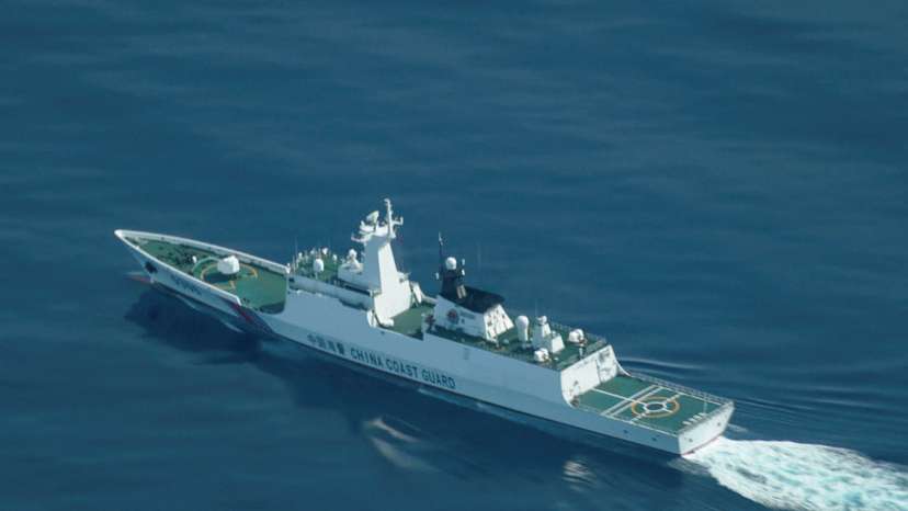 An aerial view of a China Coast Guard ship navigating near the disputed Scarborough Shoal, as Philippine Coast Guard aircraft carrying journalists patrols the area