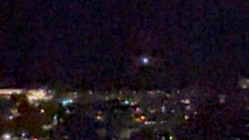 A light moves in the sky over Aalborg, amid reports of drone sightings that led to the city's airport, used for commercial and military flights, being closed due to drones in its airspace, in Aalborg