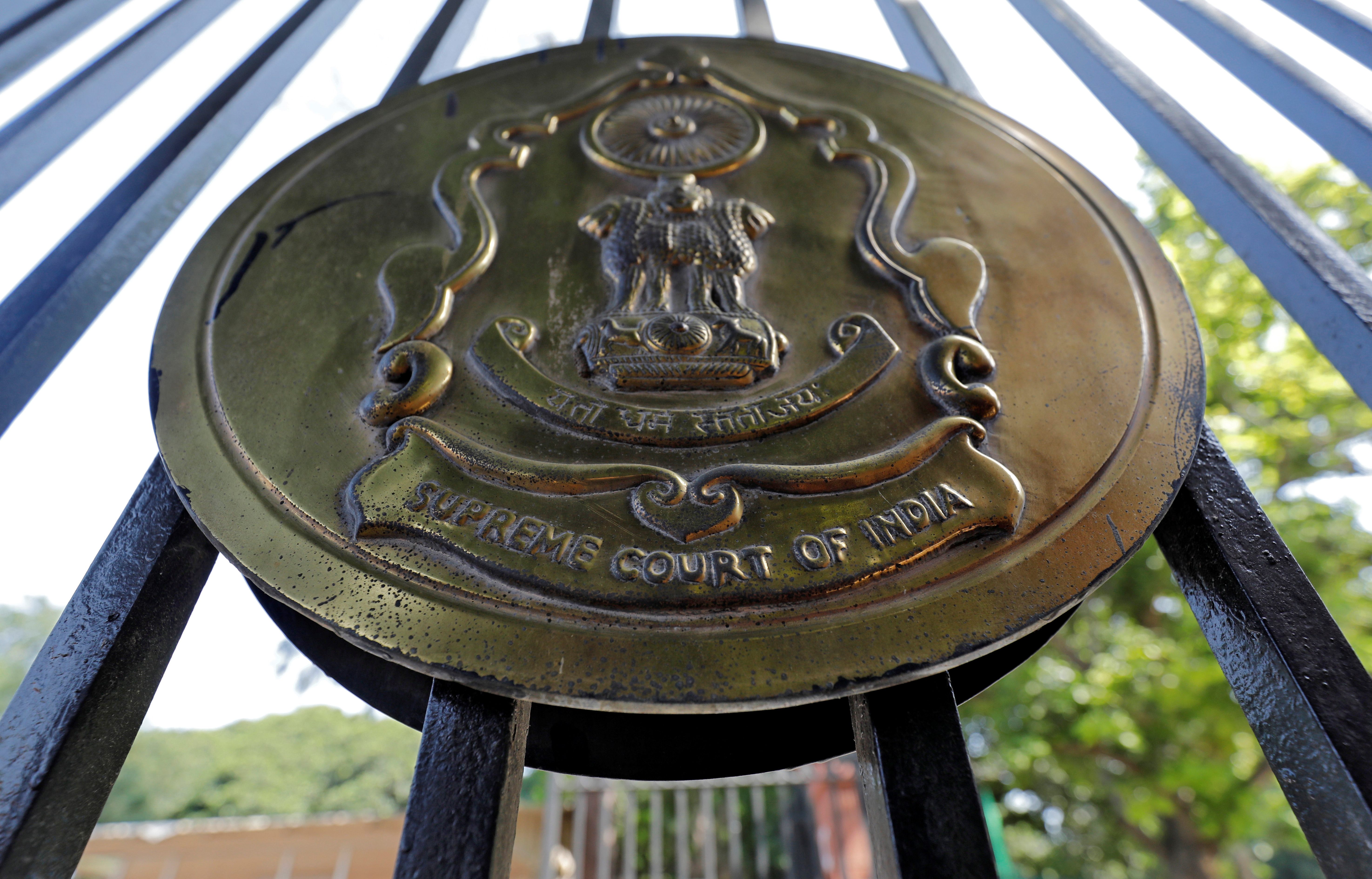 The emblem of the Supreme Court is seen on a gate of the court in New Delhi