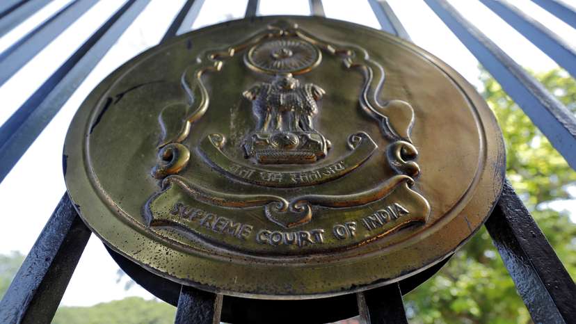 The emblem of the Supreme Court is seen on a gate of the court in New Delhi