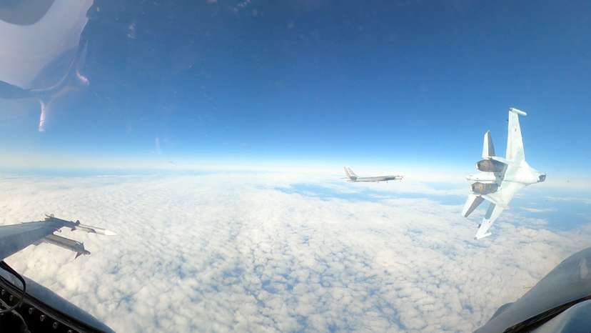 A handout image of Russian military aircraft flying next to U.S. F-16 aircraft in the Alaska ADIZ