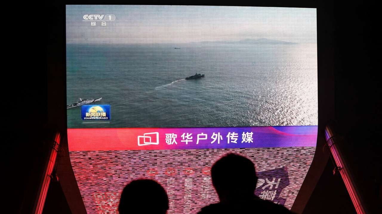 Screen shows news footage of military drills conducted in areas around the island of Taiwan by the Eastern Theatre Command of the Chinese PLA, in Beijing
