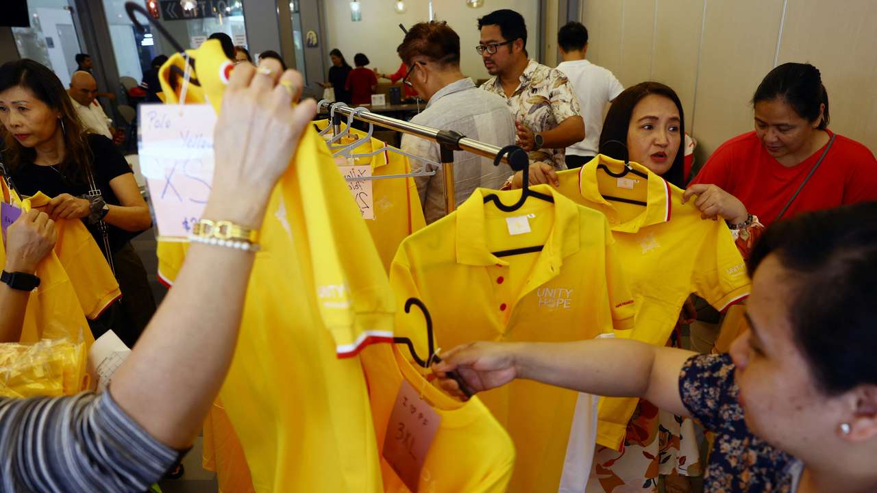 People shop for official souvenirs of the papal visit at Church of St Mary of the Angels in Singapore