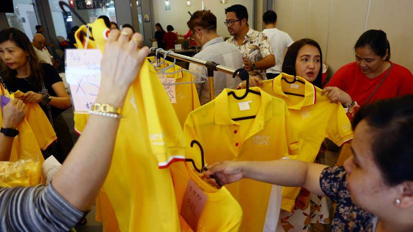 People shop for official souvenirs of the papal visit at Church of St Mary of the Angels in Singapore