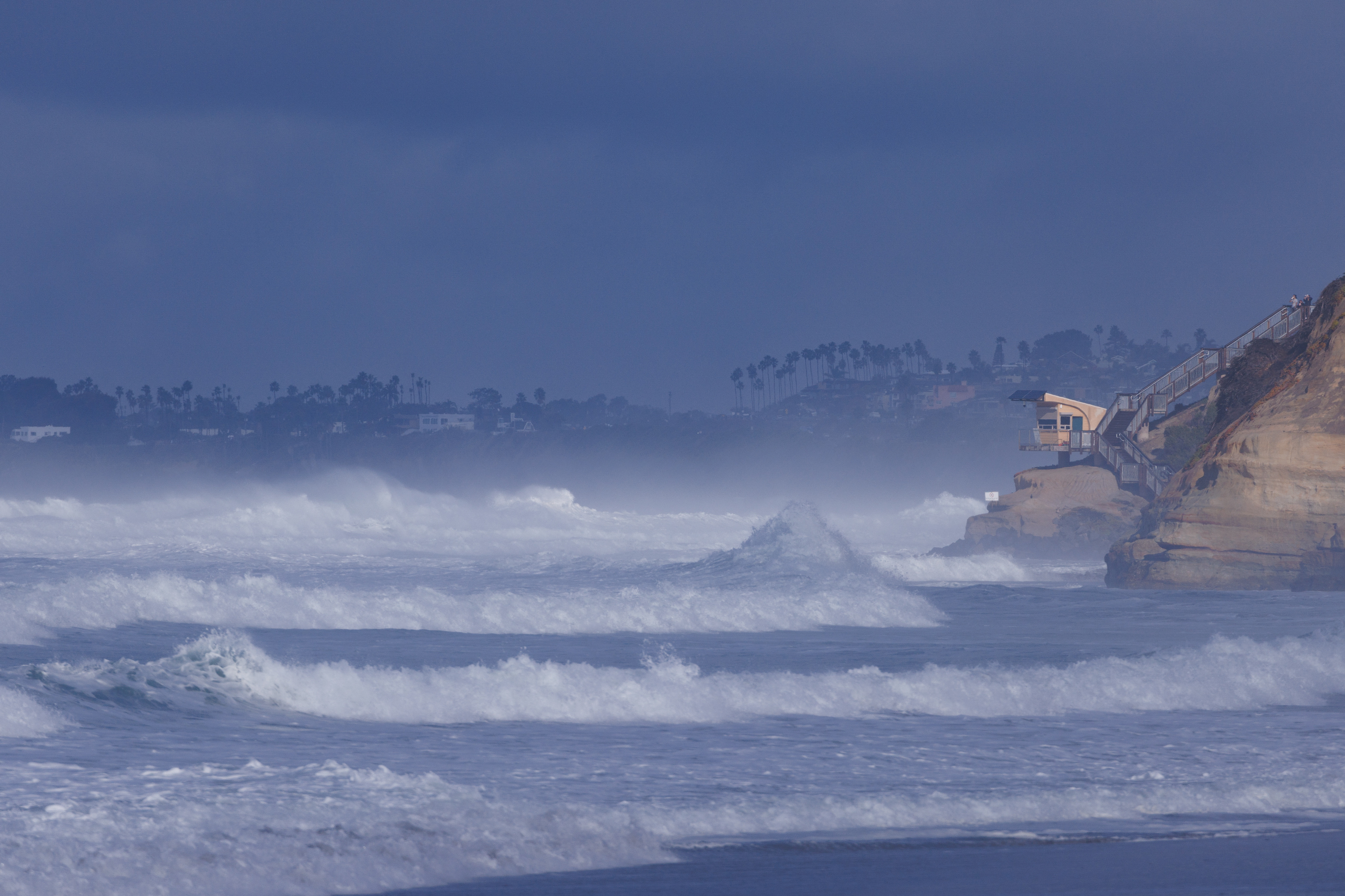 Large ocean waves come ashore in Solana Beach, California