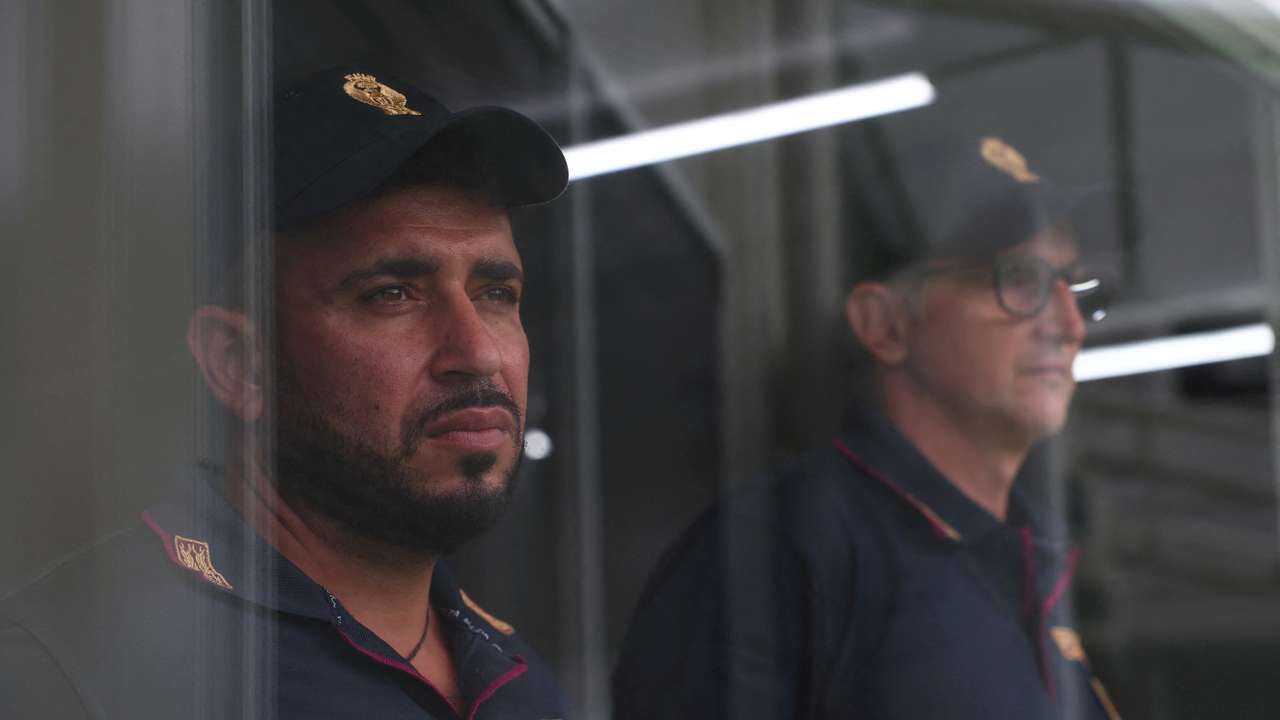 FILE PHOTO: Italian police officers stand inside the reception camp at the port where Italy will process illegal migrants