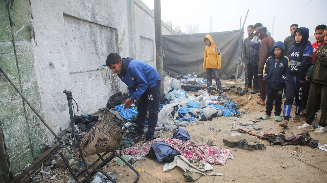 Palestinian boys inspect the damage to a tent for displaced people, after an Israeli airstrike, in Khan Younis