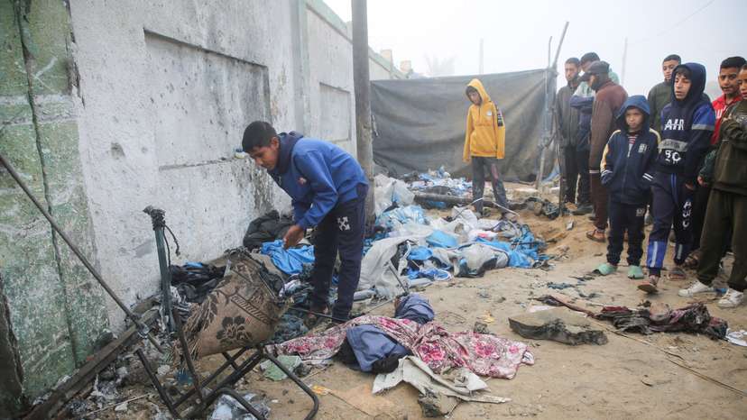 Palestinian boys inspect the damage to a tent for displaced people, after an Israeli airstrike, in Khan Younis