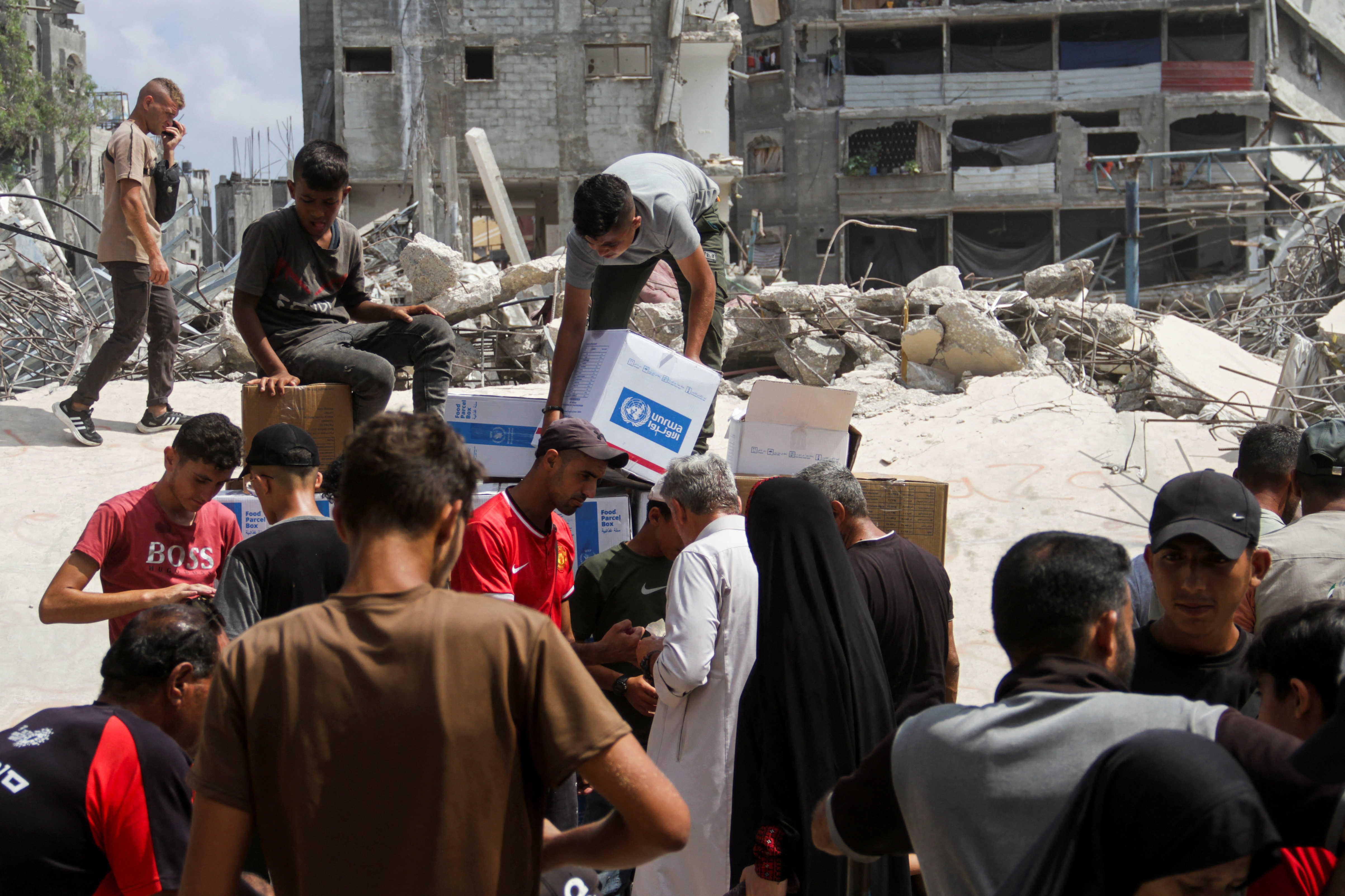 Palestinians gather to receive aid, in Jabalia, northern Gaza Strip