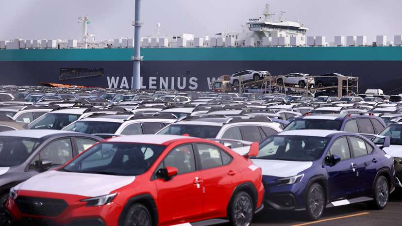 Newly manufactured cars awaiting export are parked at a port in Yokohama