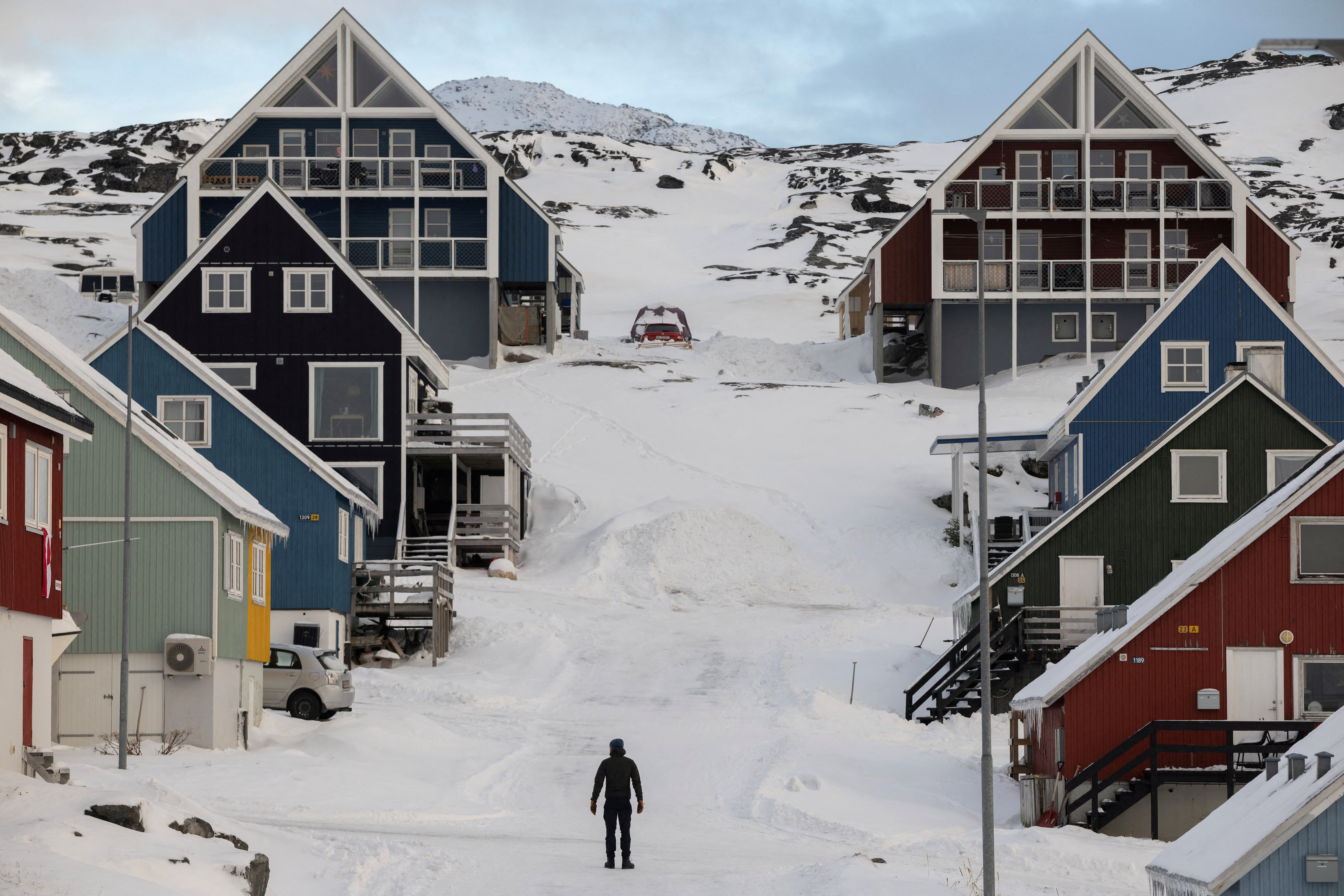 FILE PHOTO: A man stands on a street on the day of the meeting between top U.S. officials and the foreign ministers of Denmark and Greenland, in Nuuk