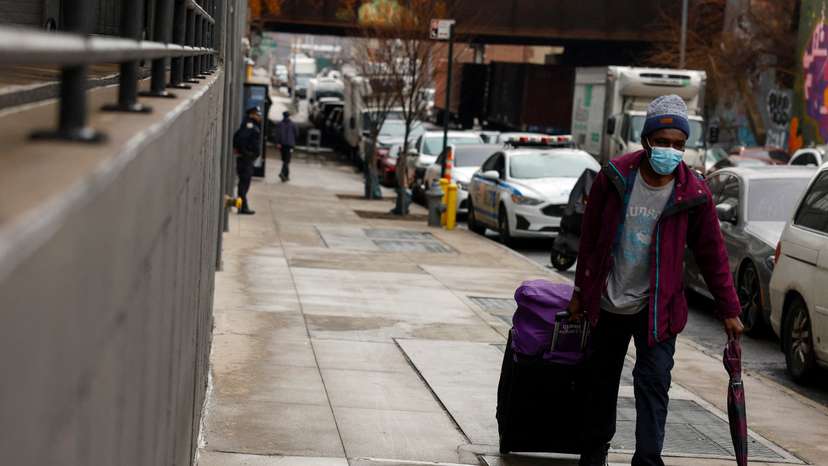 FILE PHOTO: A man walks with his belongings before entering a new migrant men's shelter in the Bronx borough of New York City