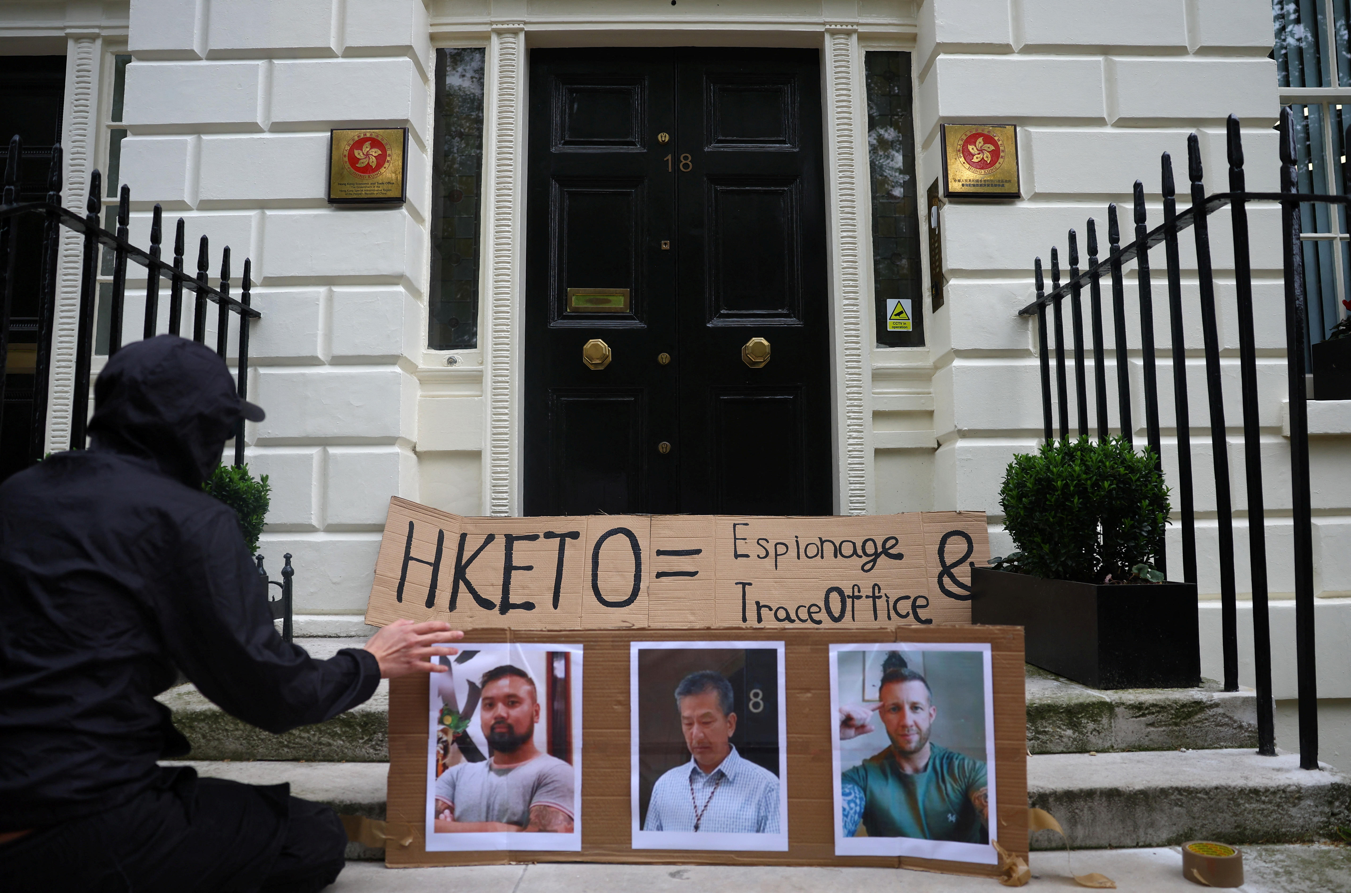 People demonstrate outside the Hong Kong Economic and Trade Office, after three men were charged with assisting Hong Kong's foreign intelligence service in Britain, in London