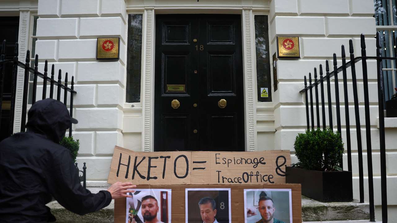 People demonstrate outside the Hong Kong Economic and Trade Office, after three men were charged with assisting Hong Kong's foreign intelligence service in Britain, in London