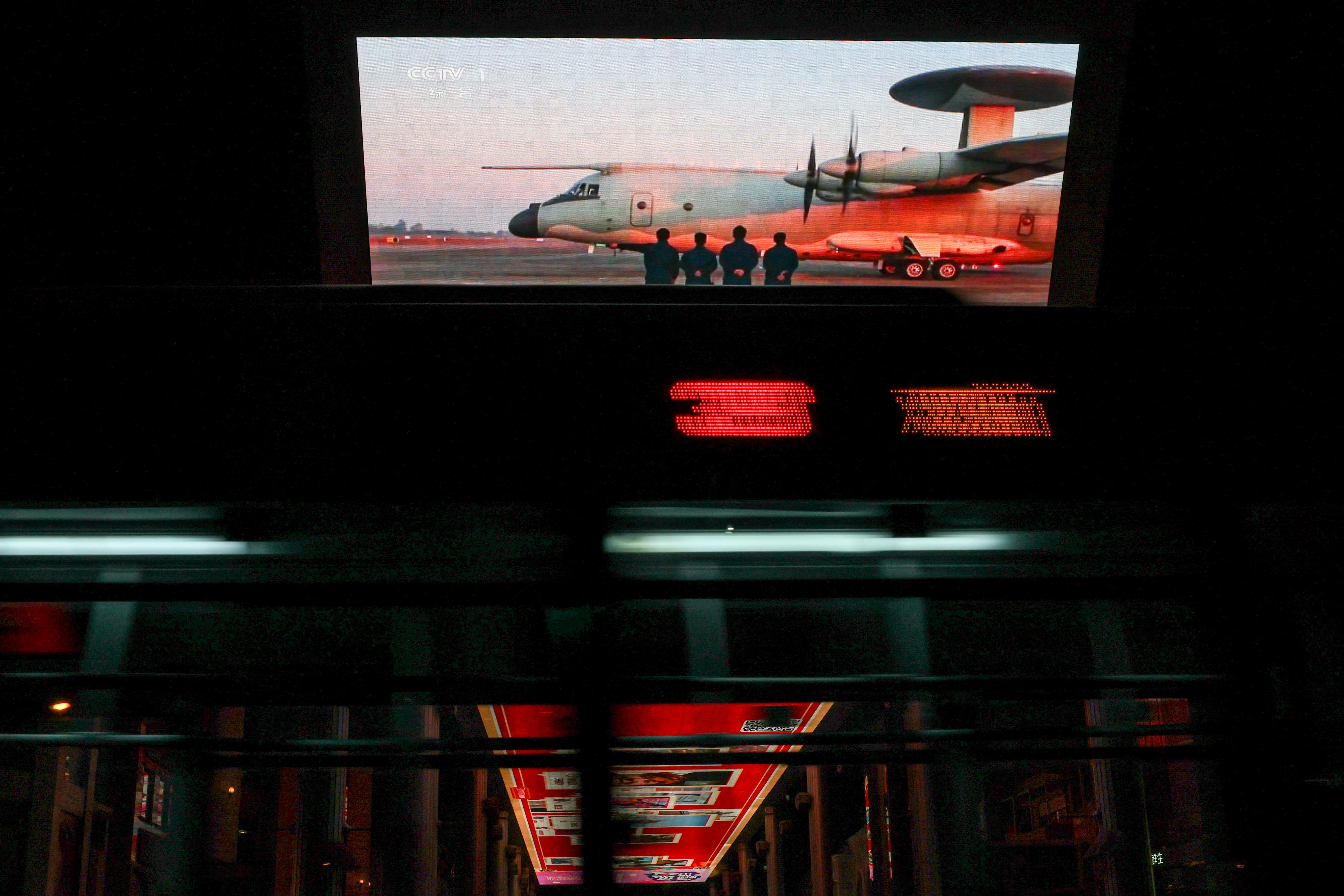 Screen showing a news report on China's military drills around Taiwan, in Beijing