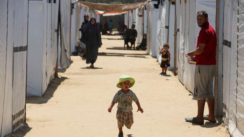 Displaced Palestinians with special needs shelter in a tent camp