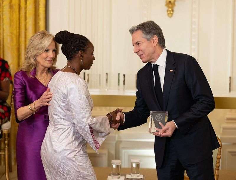 Gambian women's rights advocate Fatou Baldeh shakes hands with US Secretary of State Antony Blinken