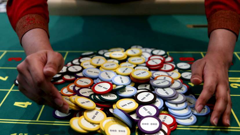 A casino dealer collects chips at a roulette table in Pasay city, Metro Manila