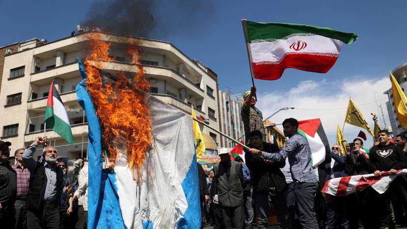 FILE PHOTO: Iranians attend a rally marking Quds Day and the funeral of members of the Islamic Revolutionary Guard Corps, in Tehran