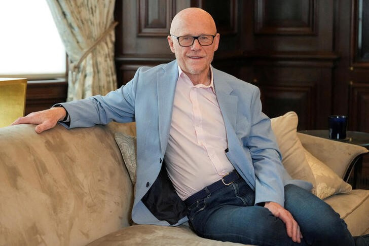 FILE PHOTO: John Caudwell, the billionaire founder of retailer Phones4u, poses for a photograph during an interview with Reuters in London