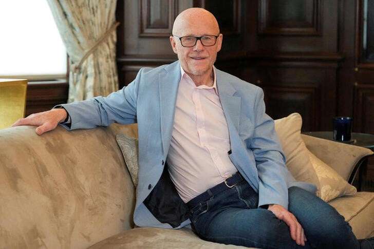 FILE PHOTO: John Caudwell, the billionaire founder of retailer Phones4u, poses for a photograph during an interview with Reuters in London