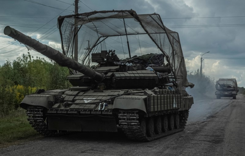 Ukrainian servicemen ride tanks near the Russian border in Sumy region