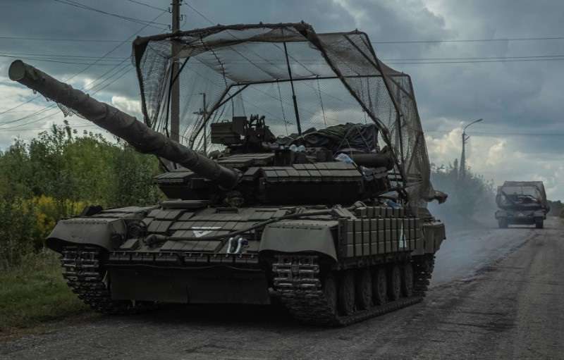 Ukrainian servicemen ride tanks near the Russian border in Sumy region