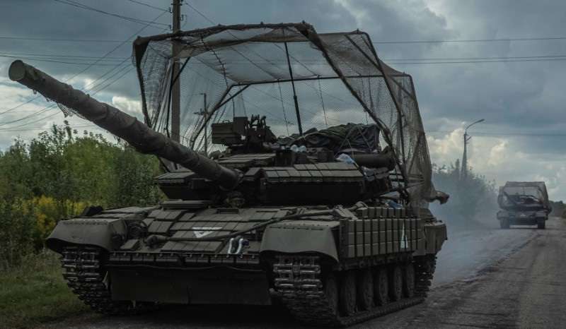 Ukrainian servicemen ride tanks near the Russian border in Sumy region