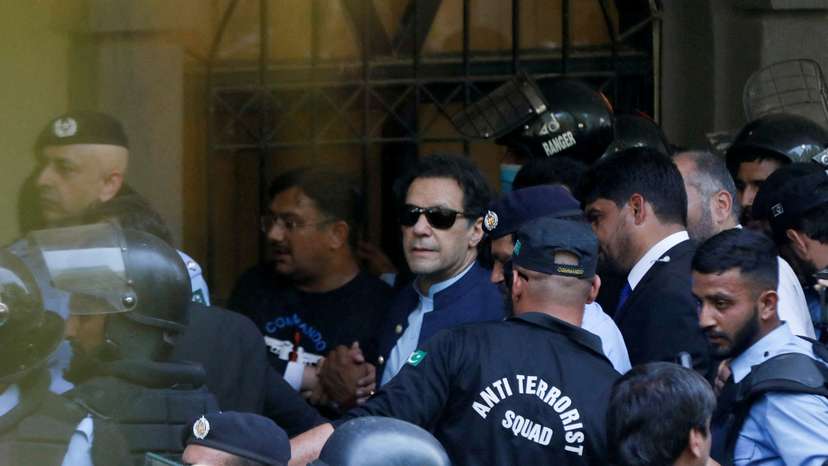 FILE PHOTO: Security officers escort Pakistan's former Prime Minister Imran Khan as he appeared in Islamabad High Court