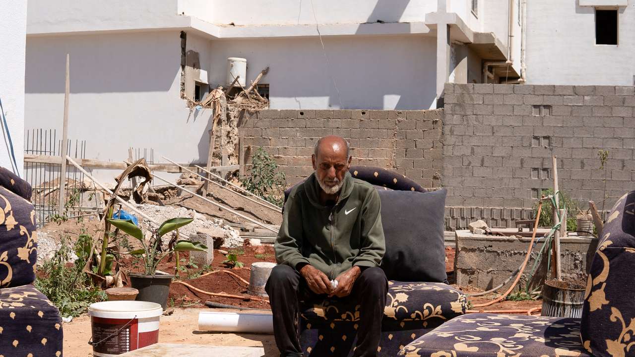 Hassan Kassar, who lost four children and a grandchild in the deadly floods last year, sits in his garden in Derna