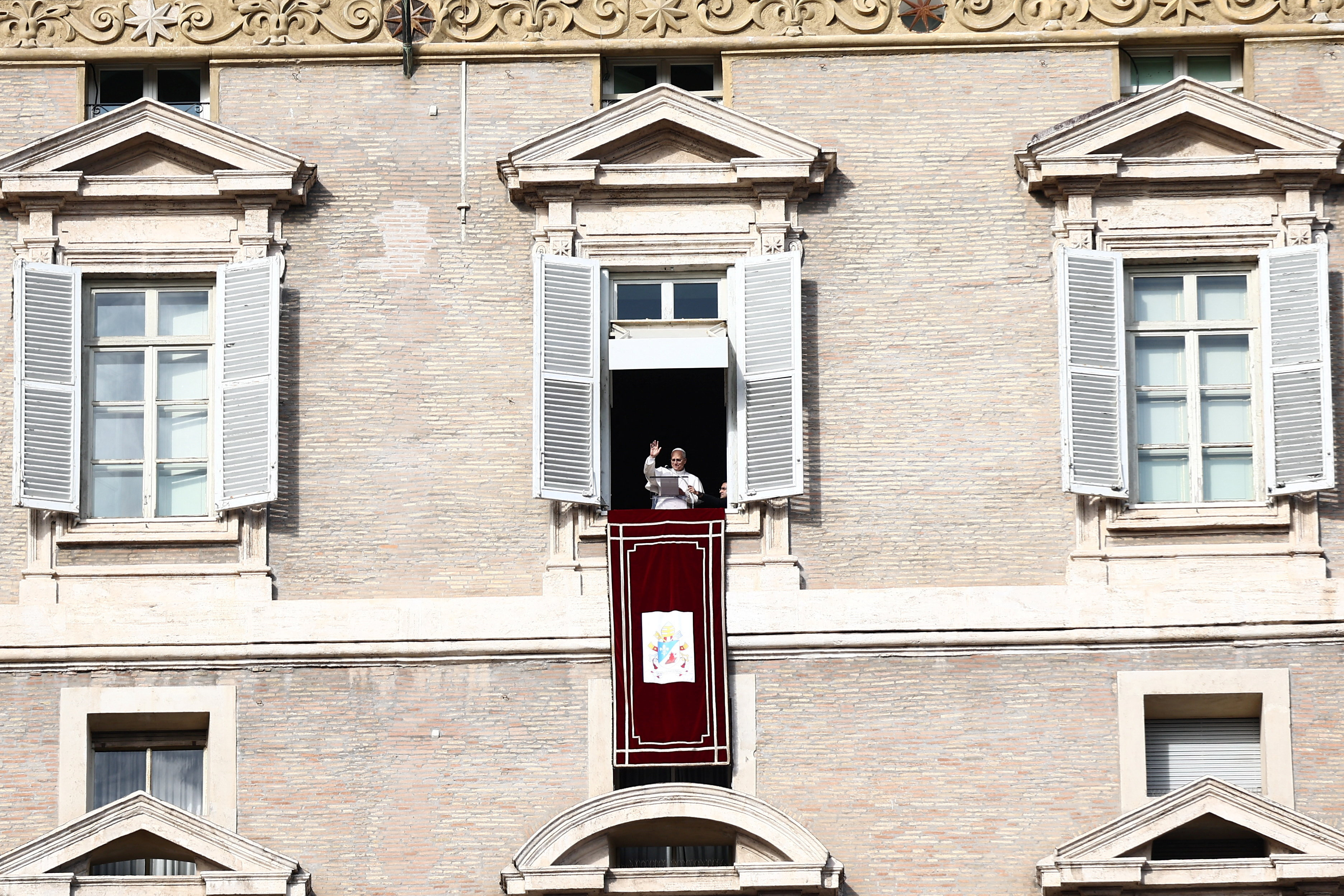 Pope Leo leads the Angelus prayer from the window of the Apostolic Palace at the Vatican