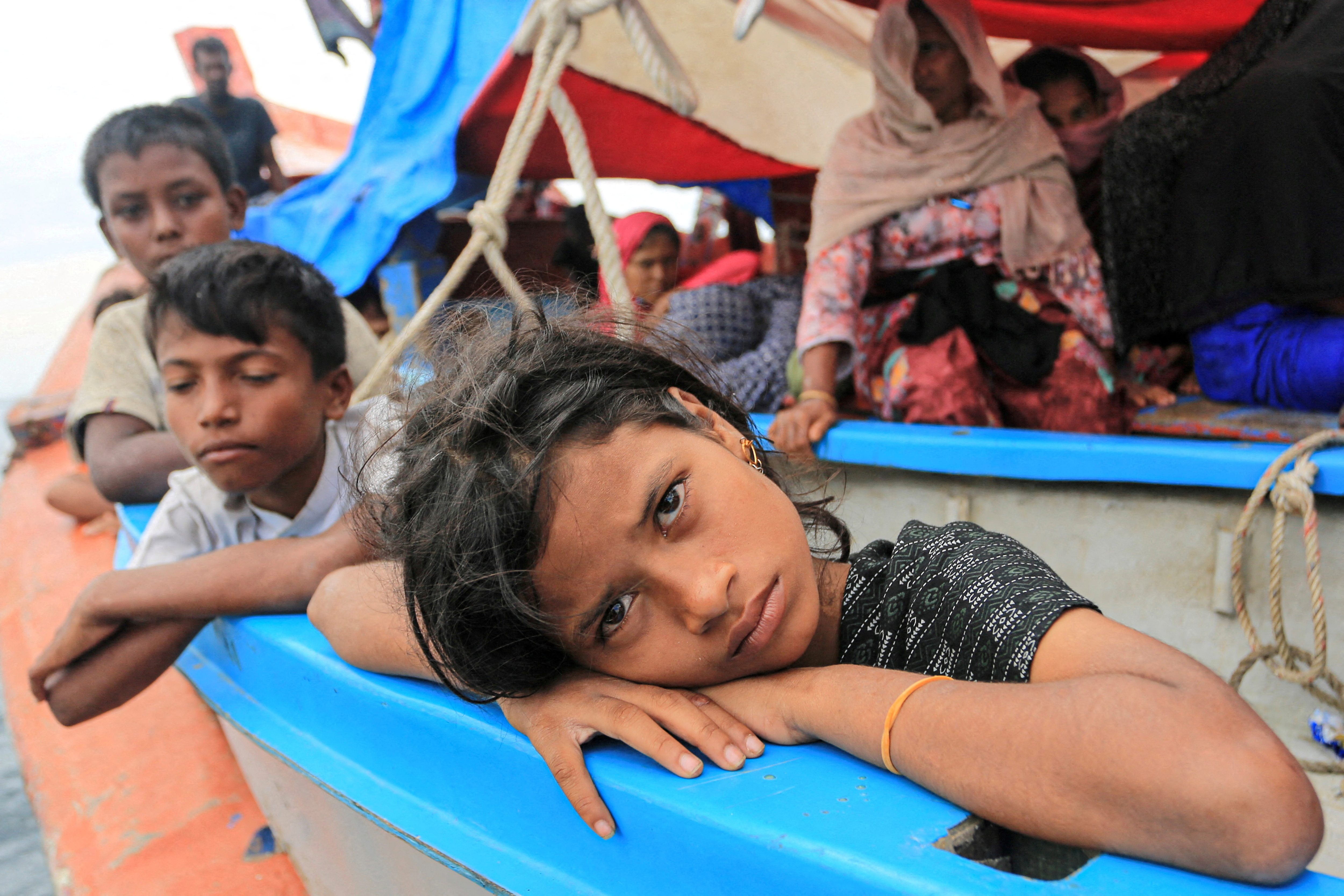FILE PHOTO: A Rohingya refugee child looks on as she is stranded due to a boat engine failure in the waters of South Aceh