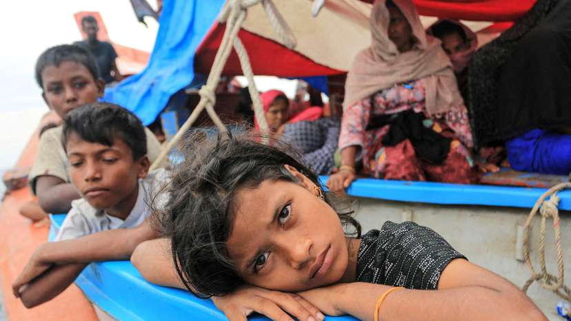 FILE PHOTO: A Rohingya refugee child looks on as she is stranded due to a boat engine failure in the waters of South Aceh