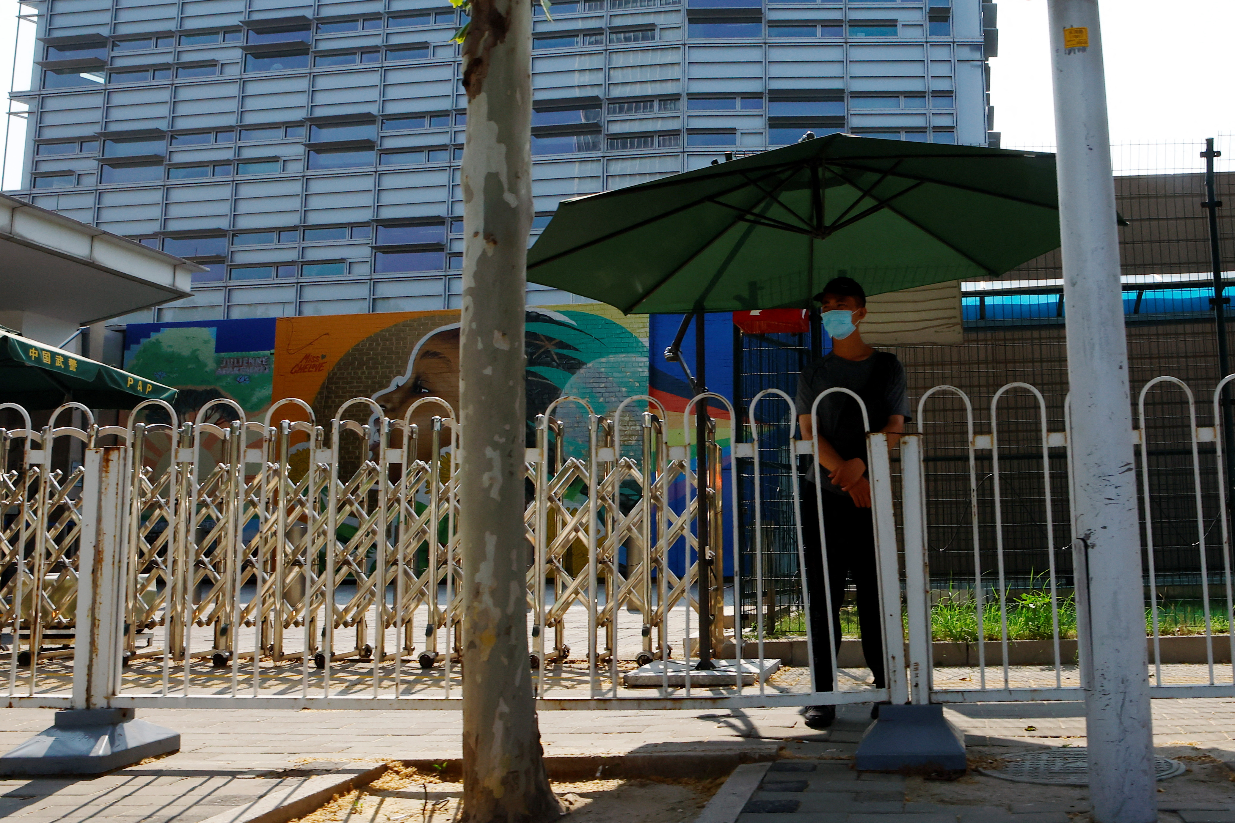 Security member keeps watch outside the U.S. embassy in Beijing