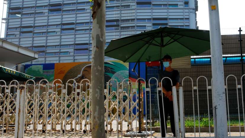 Security member keeps watch outside the U.S. embassy in Beijing