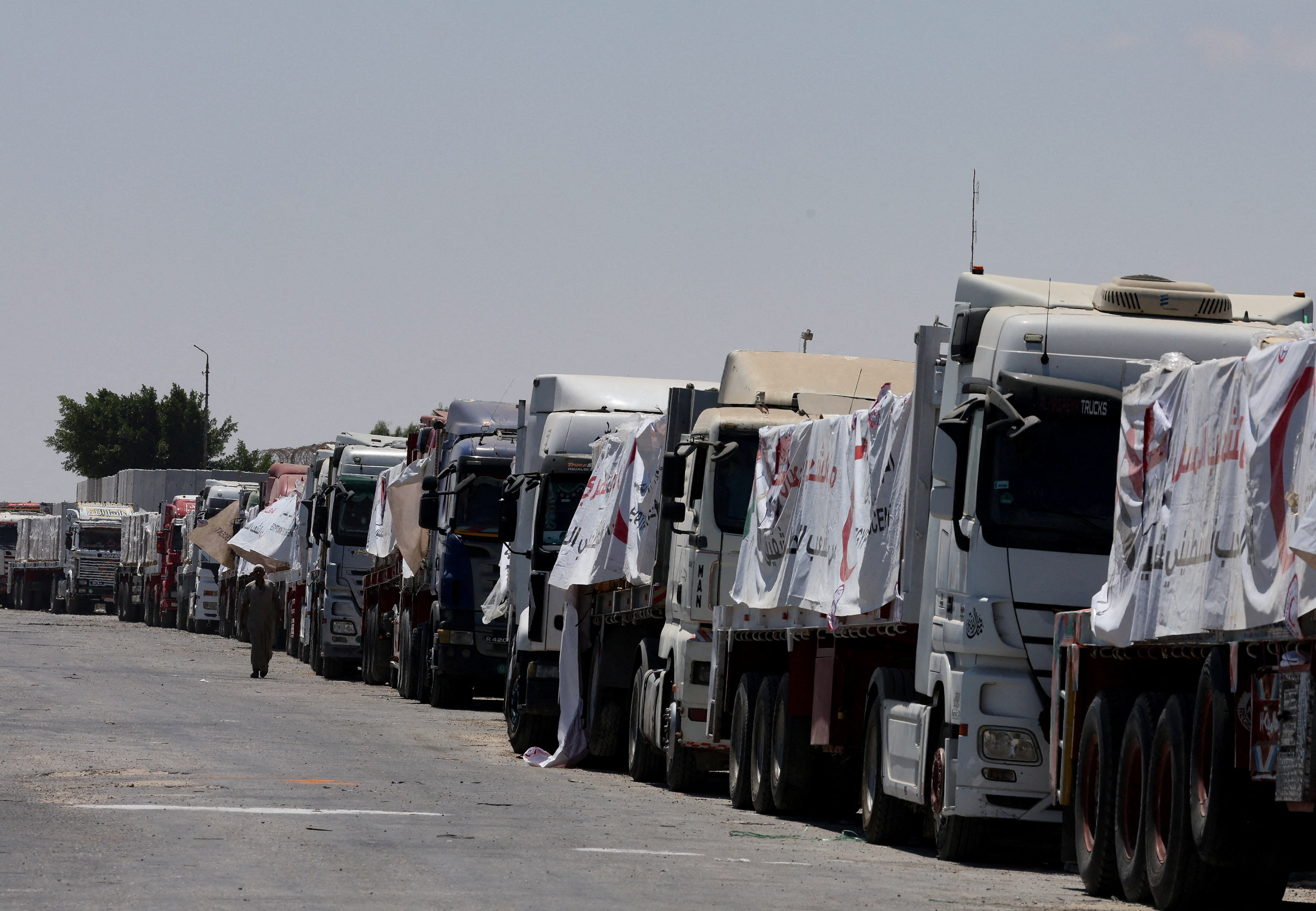 Trucks carrying humanitarian aid line up near the Rafah border crossing, in Rafah
