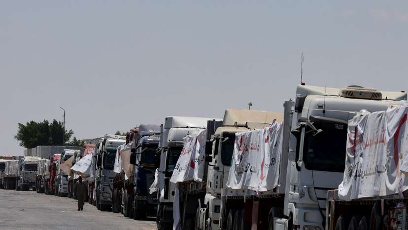 Trucks carrying humanitarian aid line up near the Rafah border crossing, in Rafah